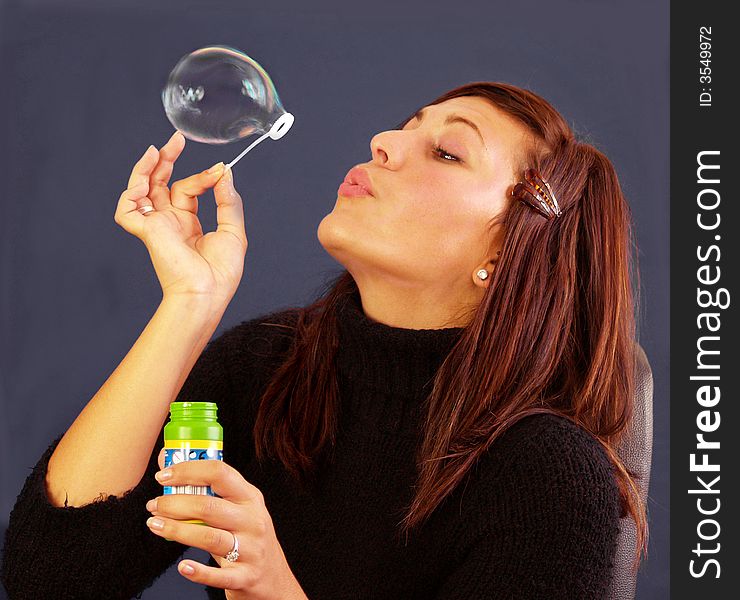 Bubbly girl blowing bubbles showing movement in bubble