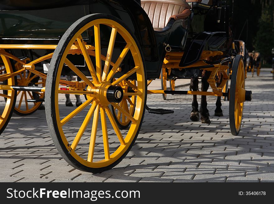 Closeup of nice vintage coach with big yellow wheel. Closeup of nice vintage coach with big yellow wheel