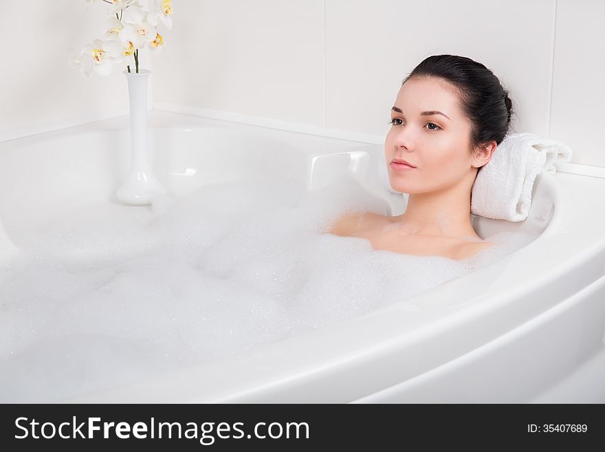 Beautiful Young Woman Takes Bubble Bath