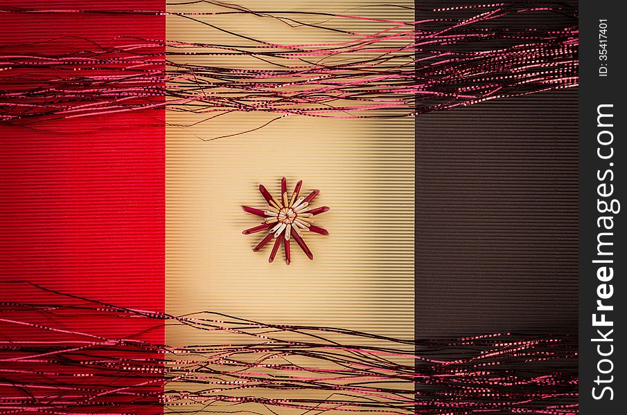 Background for Christmas greeting card- holiday straw decoration, red and yellow color textured paper