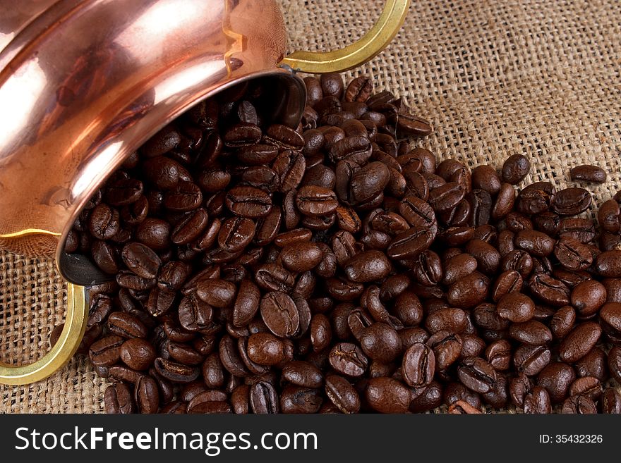 Fresh toasted coffee beans with copper cup