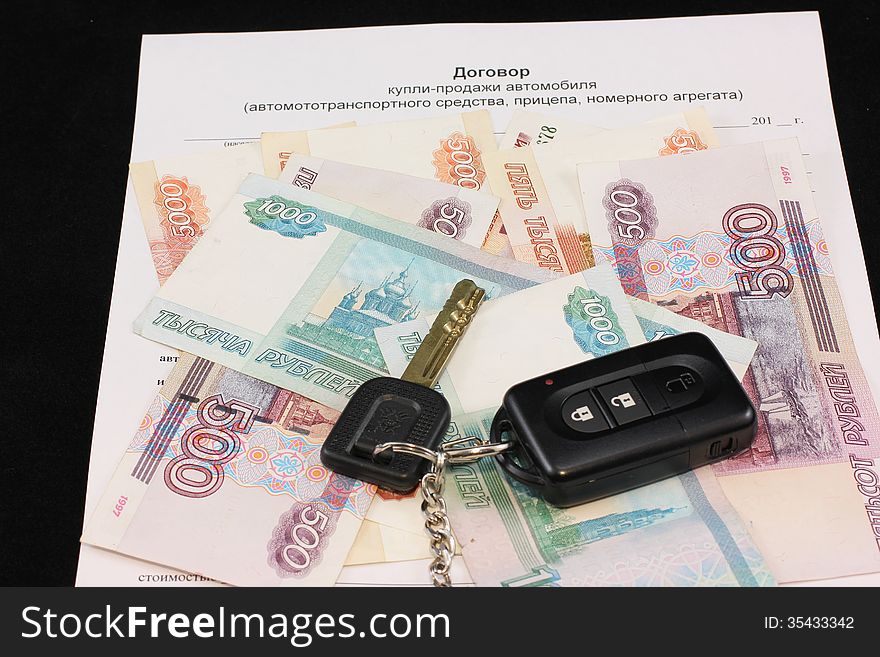 The contract of purchase - sale with keys on a black background