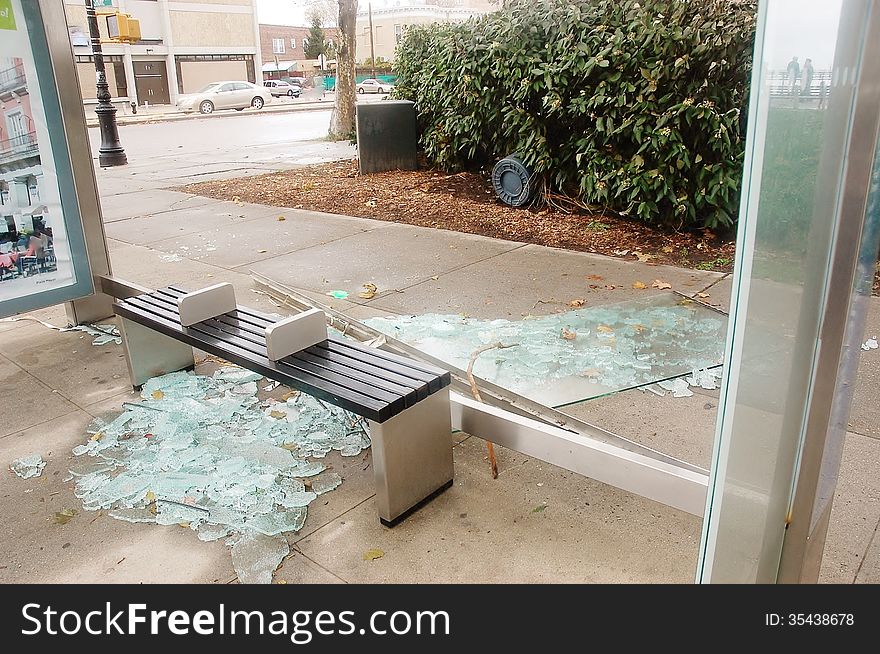 Broken glass at the bus stop is action of wind or vandals ,but any way its dangerous for passengers or pedestrians