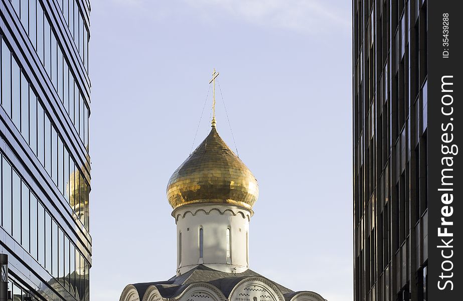 Orthodoxy church between skyscrapers in Moscow near metro Belorusskaya