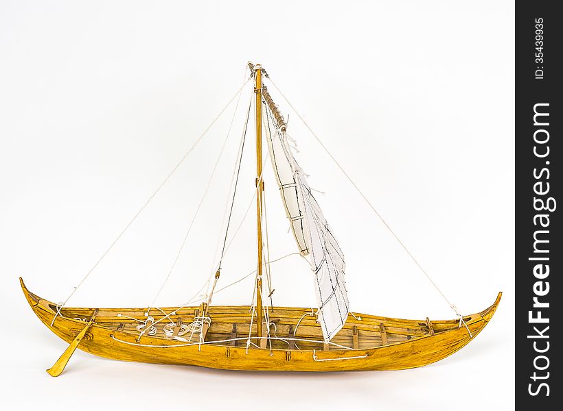 Wooden model Viking ship . White background. Side view. Wooden model Viking ship . White background. Side view