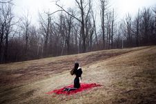 Woman In Black Dress And Long Hair Sitting On Red Carpet In Cold Forest Stock Images Woman In Black Dress And Long Hair Sitting On Red Carpet In Cold Forest Stock Images