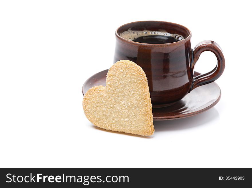 Black coffee and cookies in the shape of heart, isolated