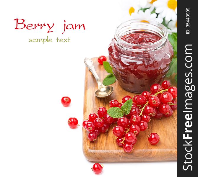 Berry jam in a glass jar and fresh red currants on a wooden board, isolated on white. Berry jam in a glass jar and fresh red currants on a wooden board, isolated on white