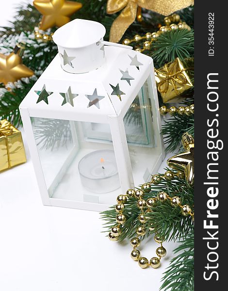 Christmas composition with a white lantern, fir branches and decorations, close-up. Christmas composition with a white lantern, fir branches and decorations, close-up