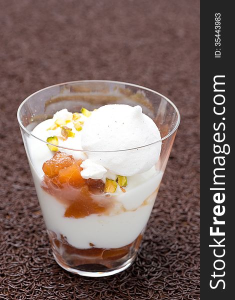 Dessert With Peaches, Whipped Cream, Meringue And Pistachios