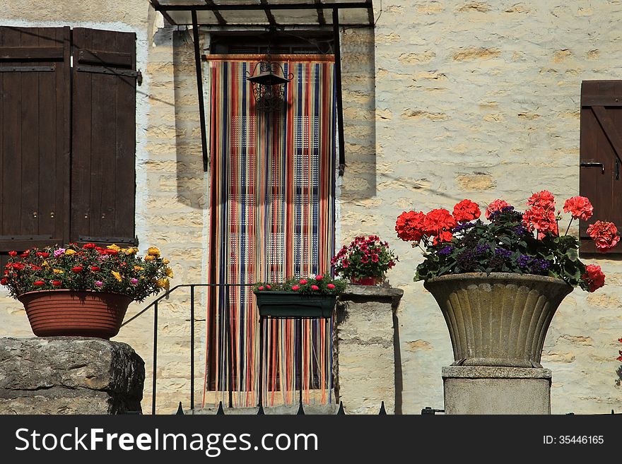 The wall of the house decorated with flowers, France