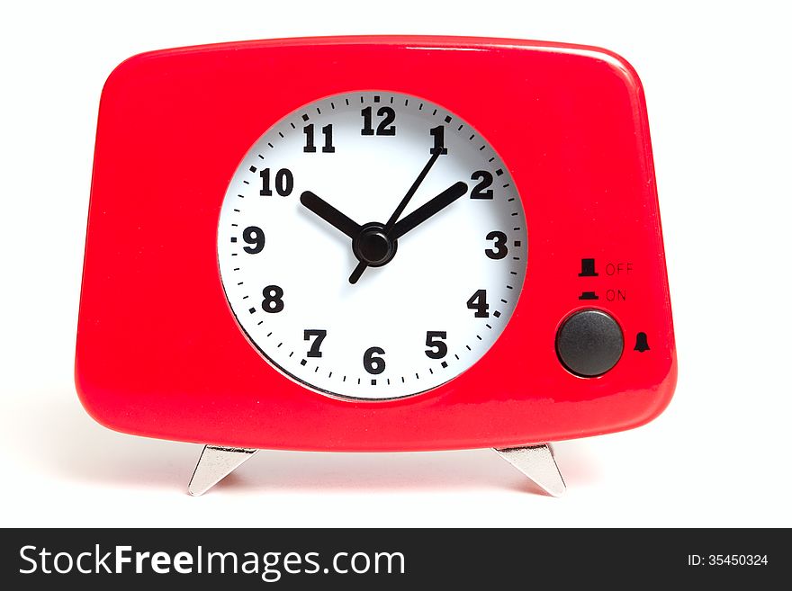 A red clock with chrome feet