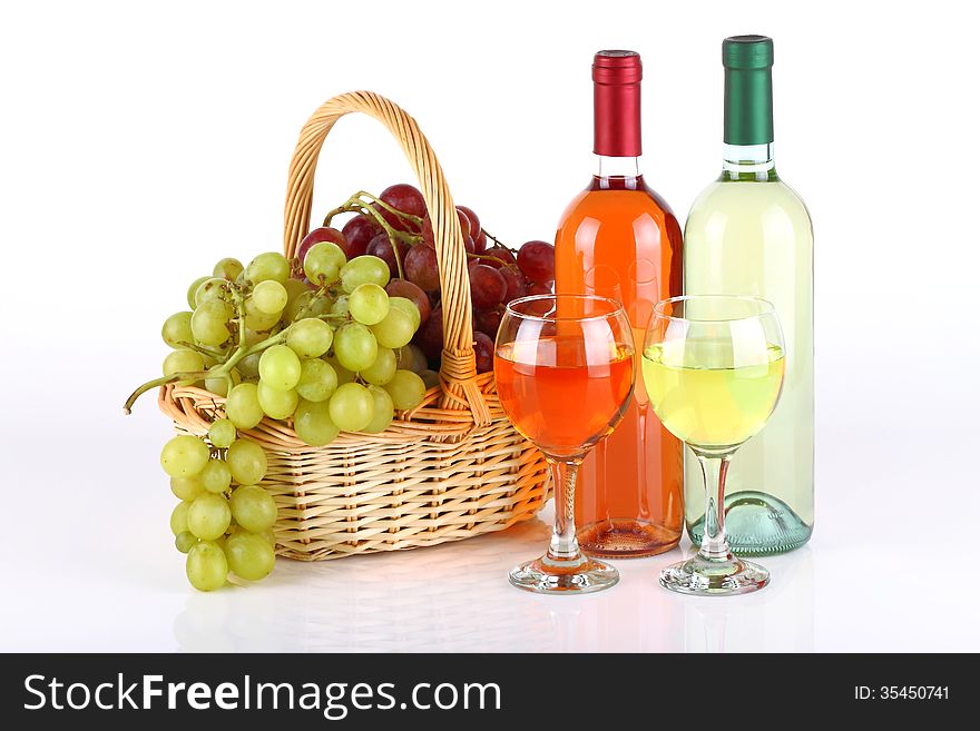 Basket with grapes and wine bottles