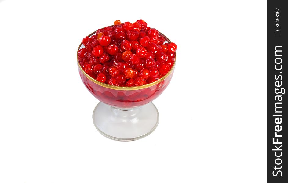 Bright red berries in a crystal vase filled with sugar syrup. Presented on a white background. Bright red berries in a crystal vase filled with sugar syrup. Presented on a white background.