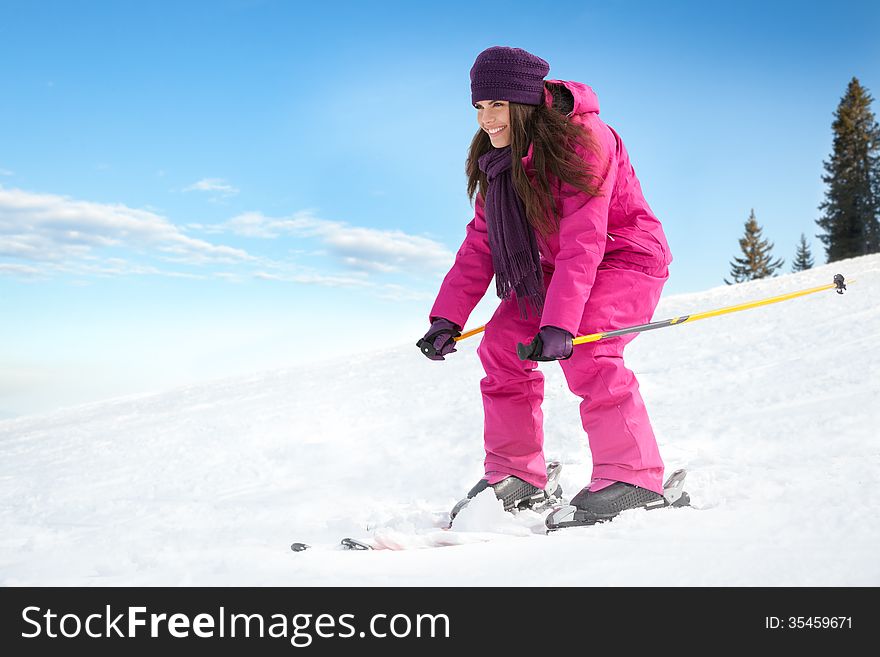 Young woman skiing fast on the slope. Winter vacation