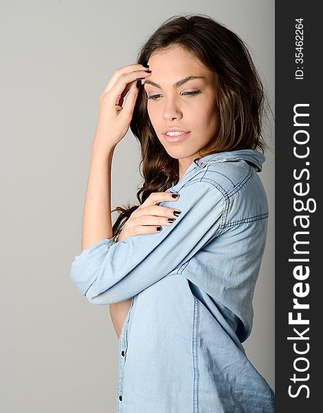 Young Casual Woman Style Over Gray Background. Studio Portrait