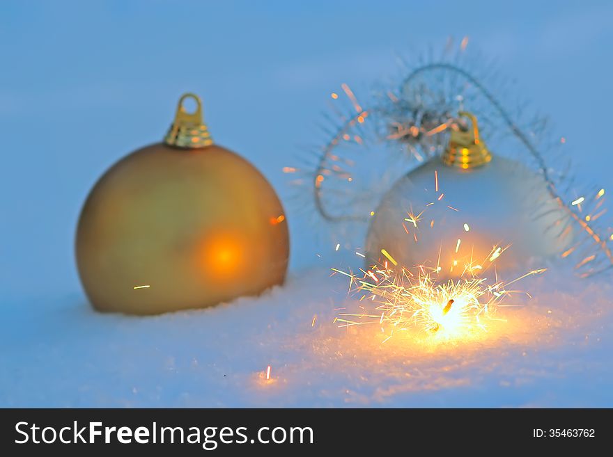 Bengal light and christmas balls  in snow