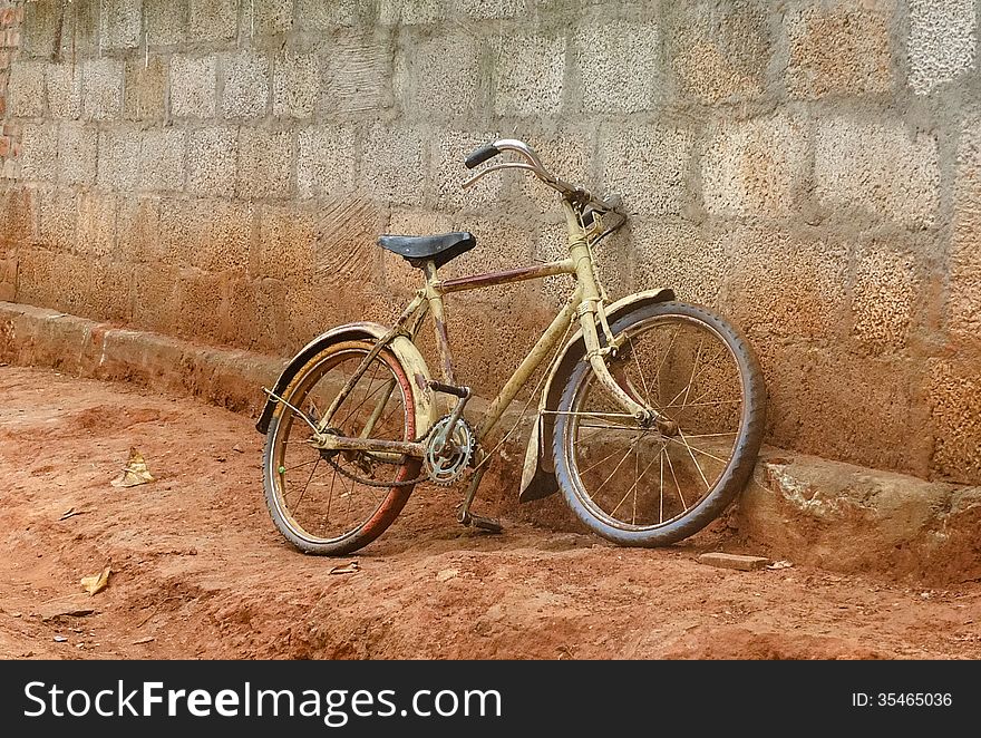 Bike against a brick wall in rural India. Bike against a brick wall in rural India