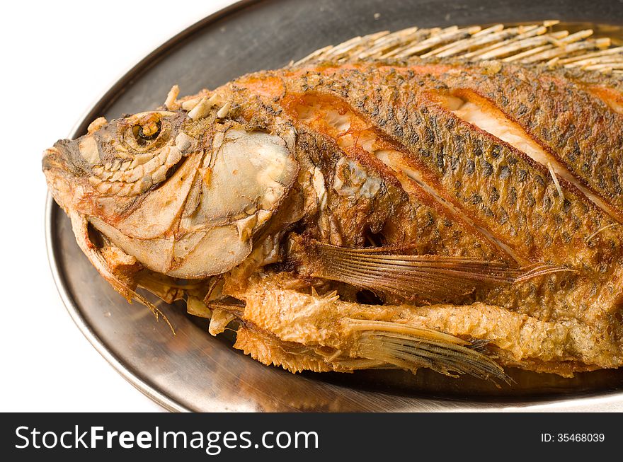 Close up fried fish in plate on white background