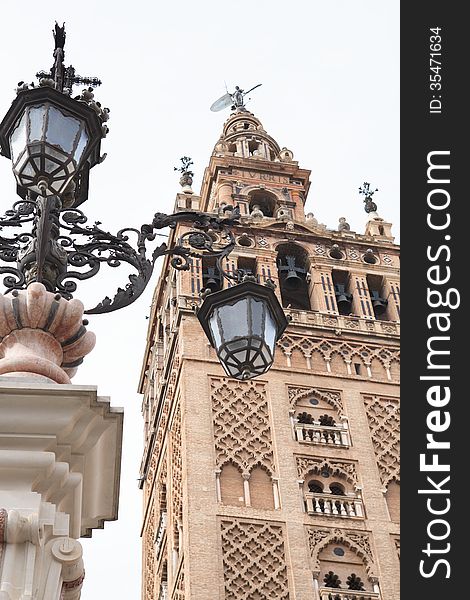 Nice old street lamp against belfry of Seville Cathedral, Spain. Nice old street lamp against belfry of Seville Cathedral, Spain