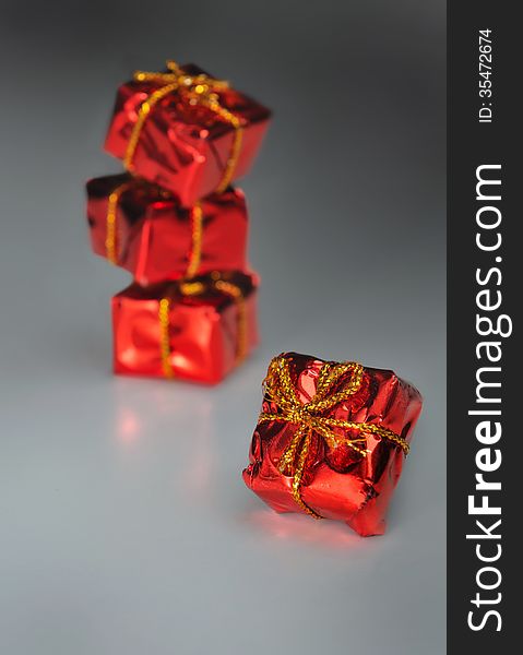 Small red gift package on dark background. Small red gift package on dark background