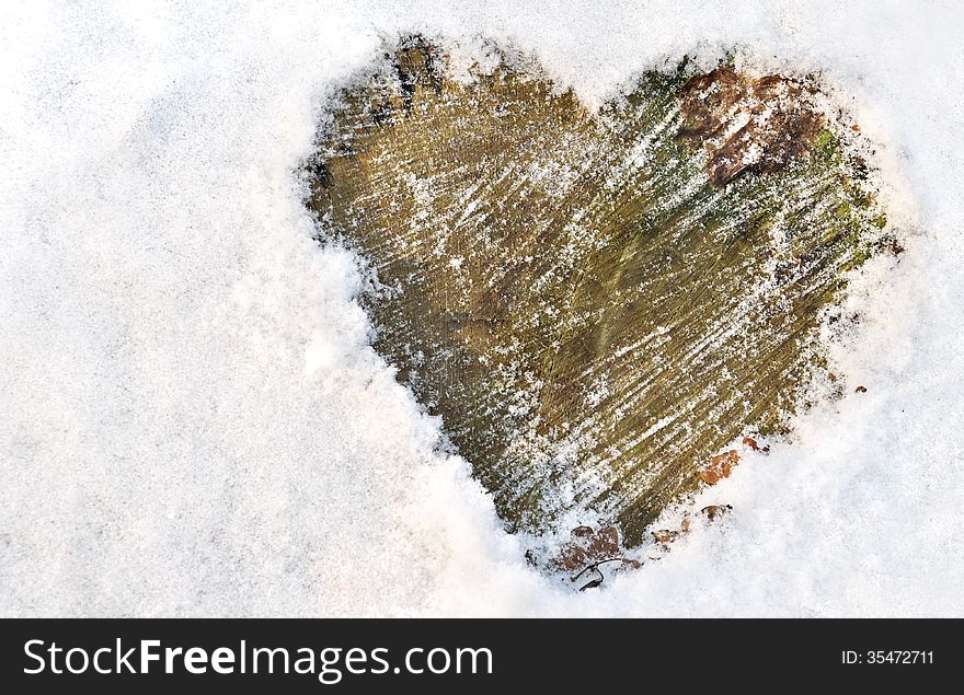 Heart drawn in the snow on wood. Heart drawn in the snow on wood