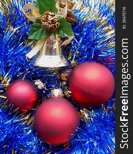 Christmas and New Year decorations red balls on a background of blue tinsel