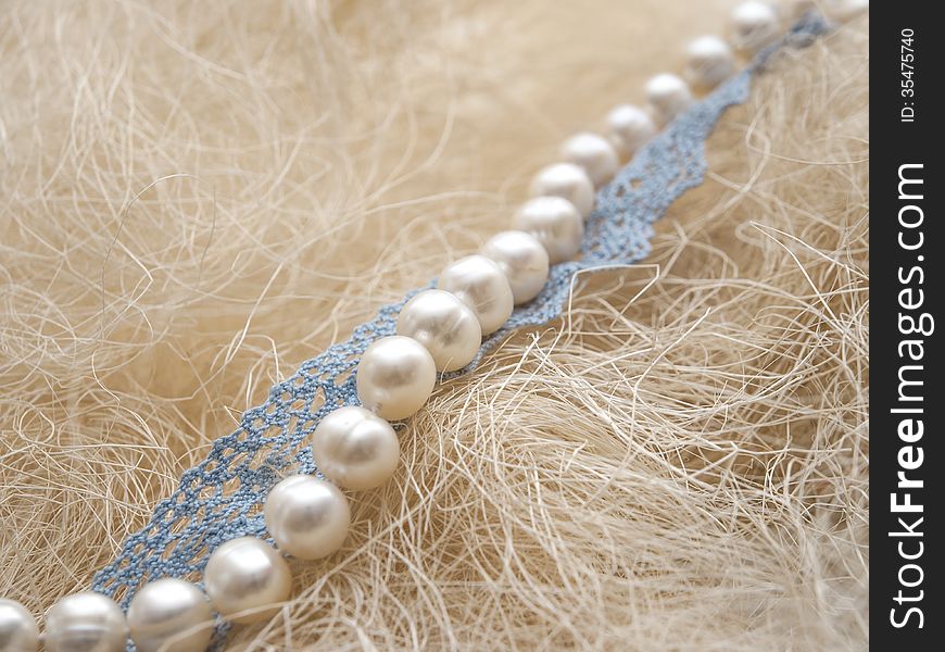 White pearl and blue lace on straw