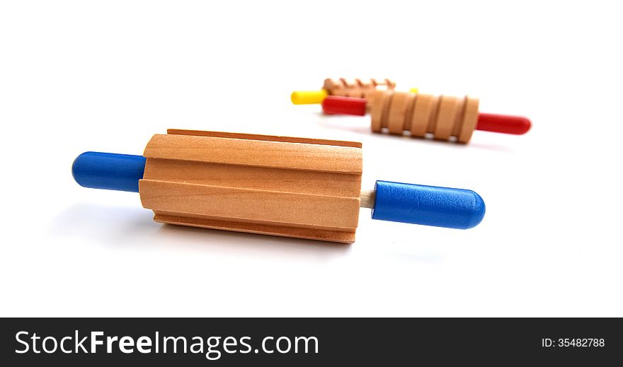 Colorful rolling pin toys, all made out of wood with a different pattern for each. Colorful rolling pin toys, all made out of wood with a different pattern for each