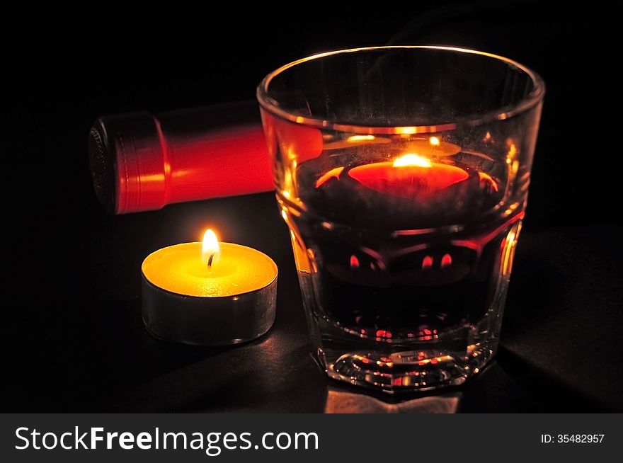 Glass of red wine with candle and bottle. Glass of red wine with candle and bottle