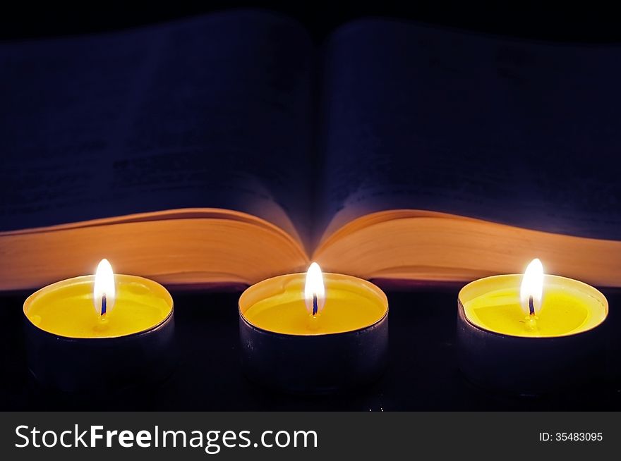Three candles with open bible. Three candles with open bible