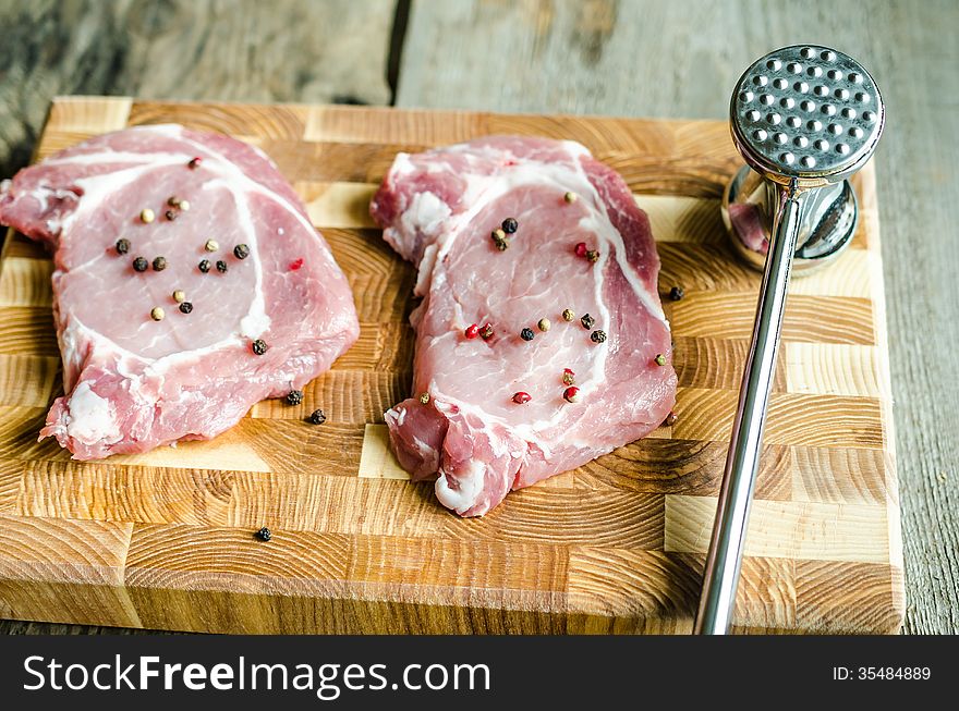 Raw pork steaks on the cutting board