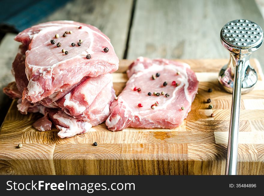 Raw pork steaks on the cutting board