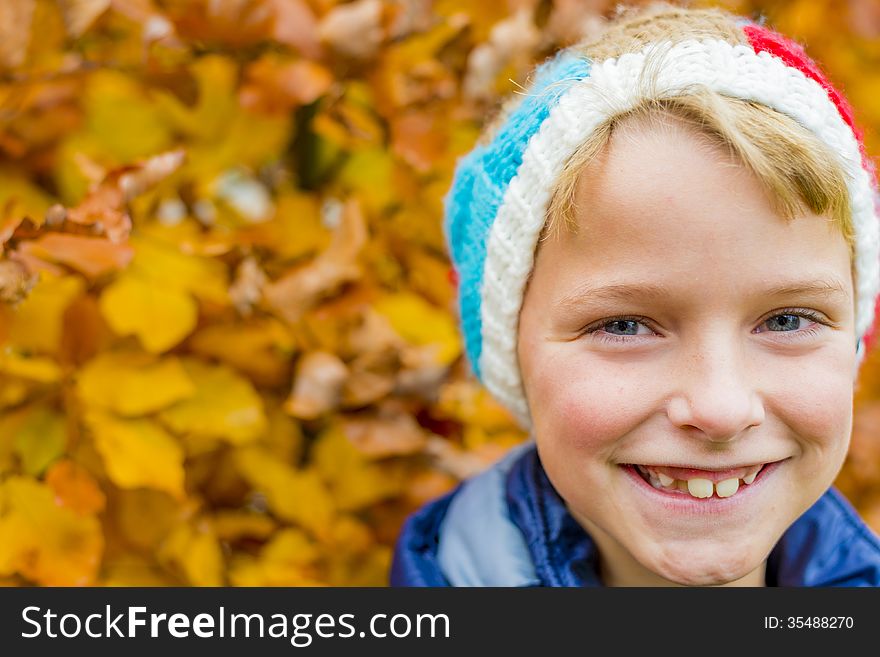 Portrait of a boy with colorful autumn leaves in the background. Portrait of a boy with colorful autumn leaves in the background