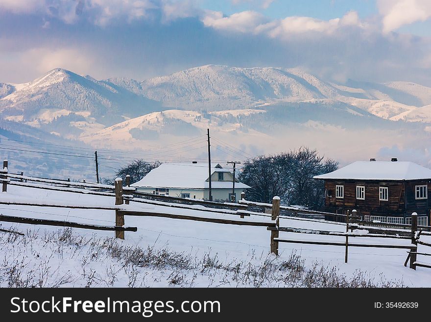 Snow-covered Mountains Behind Two Cotteges