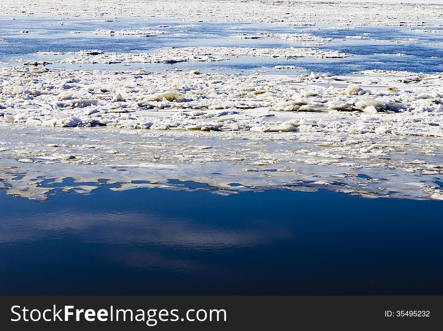 Ice drift on the river the late fall in the bright sunny day