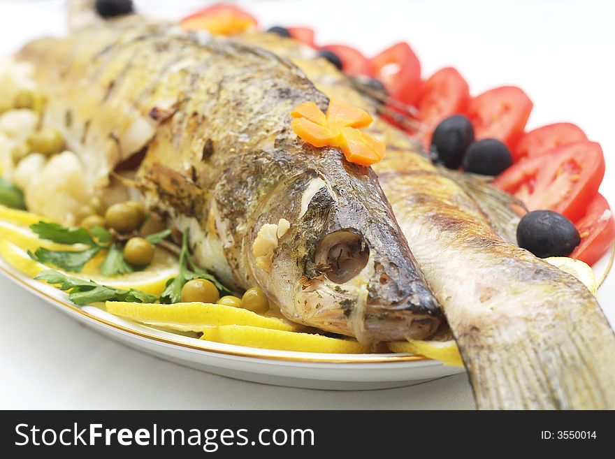 Baked fish with mixed greens garnish