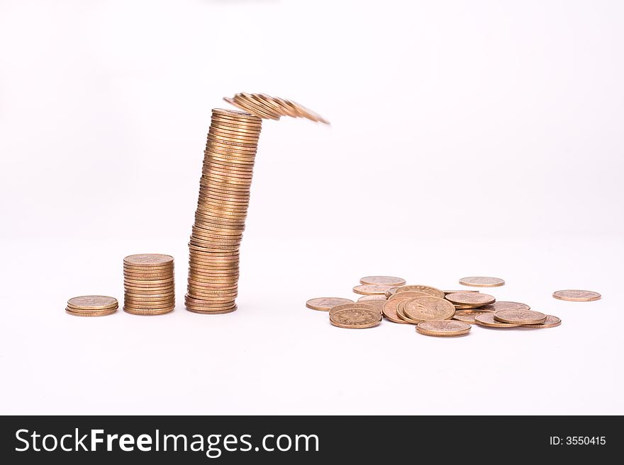 Piles of yellow coins against white background. Last one is falling. Piles of yellow coins against white background. Last one is falling.