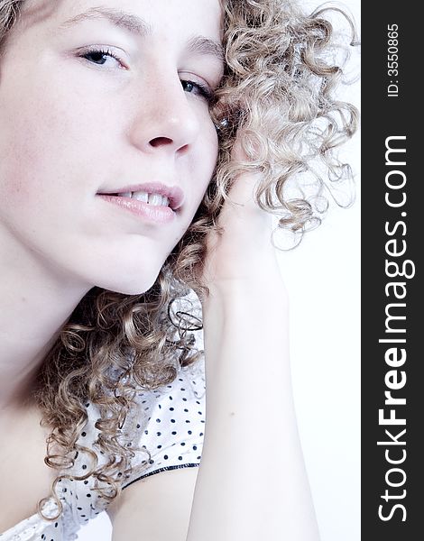 Girls portrait with curly hair on a white background. Girls portrait with curly hair on a white background