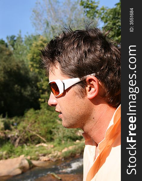Young male model profile looking down, wearing white sunglasses