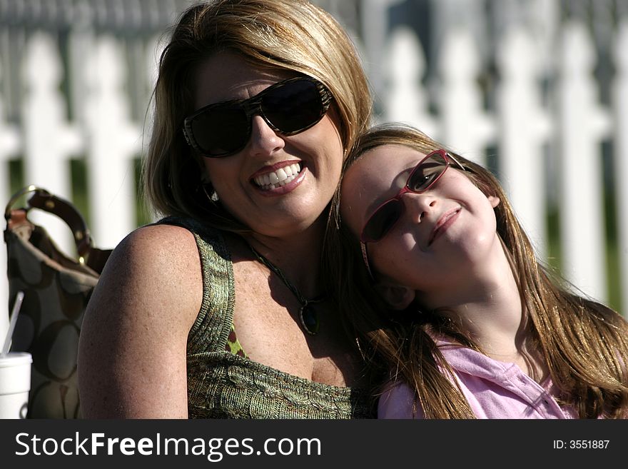 Woman and child both wearing glasses and smiling. Woman and child both wearing glasses and smiling