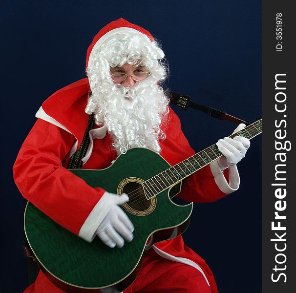 Santa singing carols at christmas on the guitar