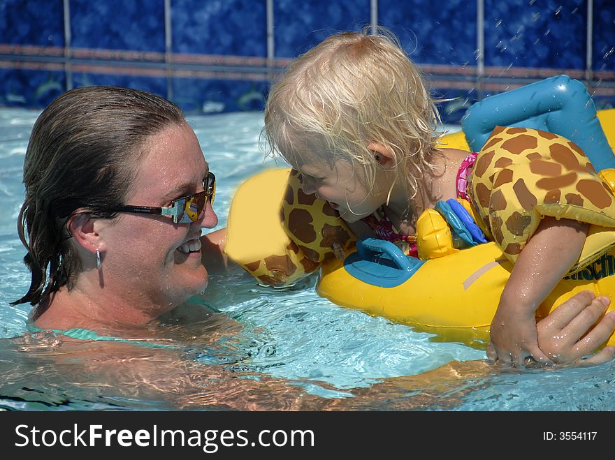 Mother and daughter in the pool. Mother and daughter in the pool