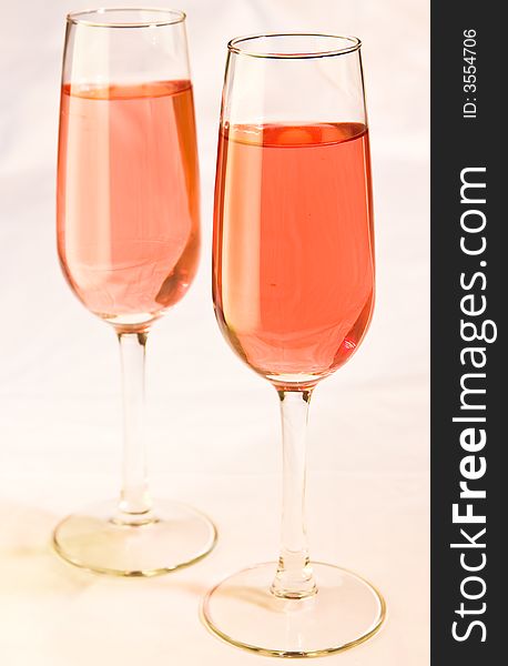 Two stylish wine glasses with pink colored wine. Two stylish wine glasses with pink colored wine