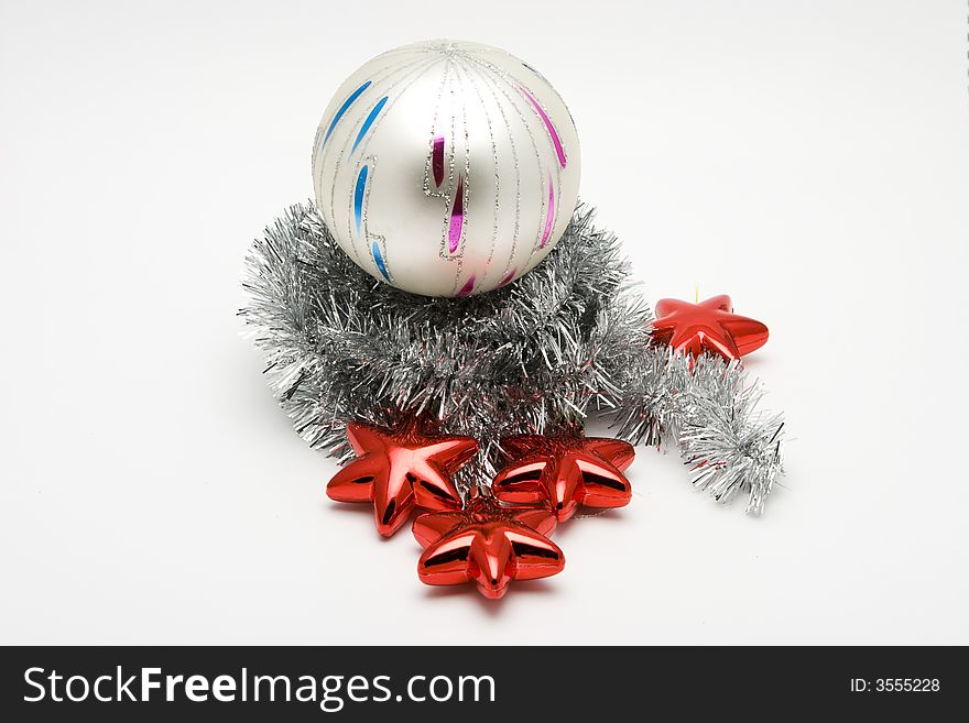 Red star shaped Christmas tree ornaments and glass ball on white background. Red star shaped Christmas tree ornaments and glass ball on white background