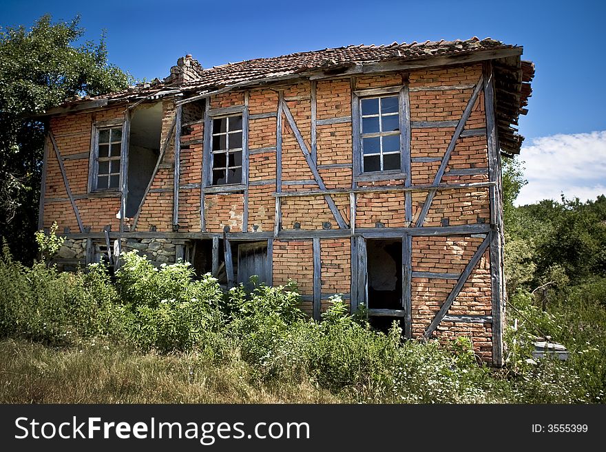 Old abandoned house surrounded with weeds. Old abandoned house surrounded with weeds