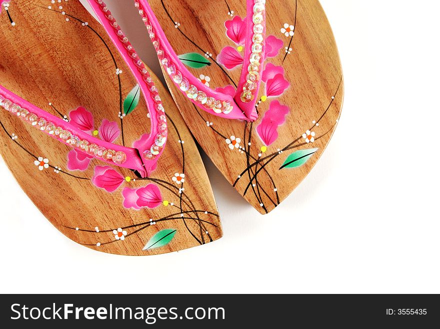 Close-up of wooden pink sandals isolated. Close-up of wooden pink sandals isolated.