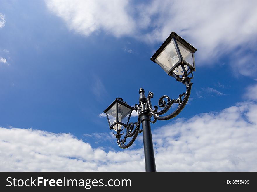 Street lamp on the background of the blue sky