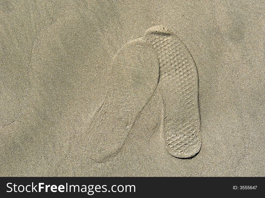 Foot prints in the sand overlapping each other