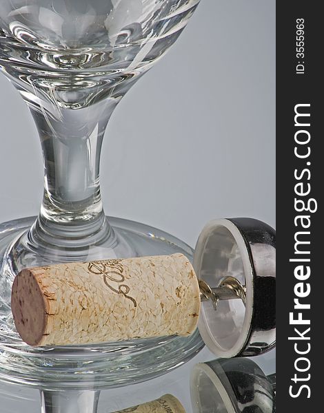 Closeup of an empty wine glass with cork in corkscrew. Closeup of an empty wine glass with cork in corkscrew.